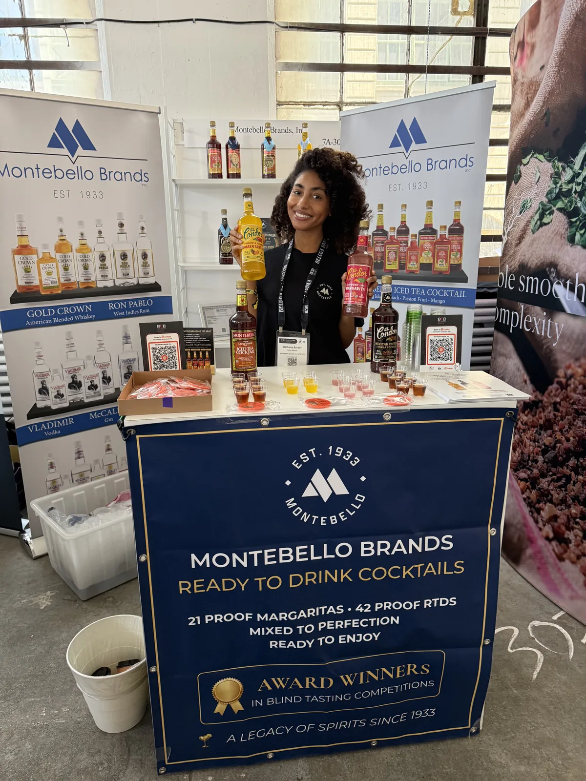 The booth table with sample cups and the Montebello Brands banners